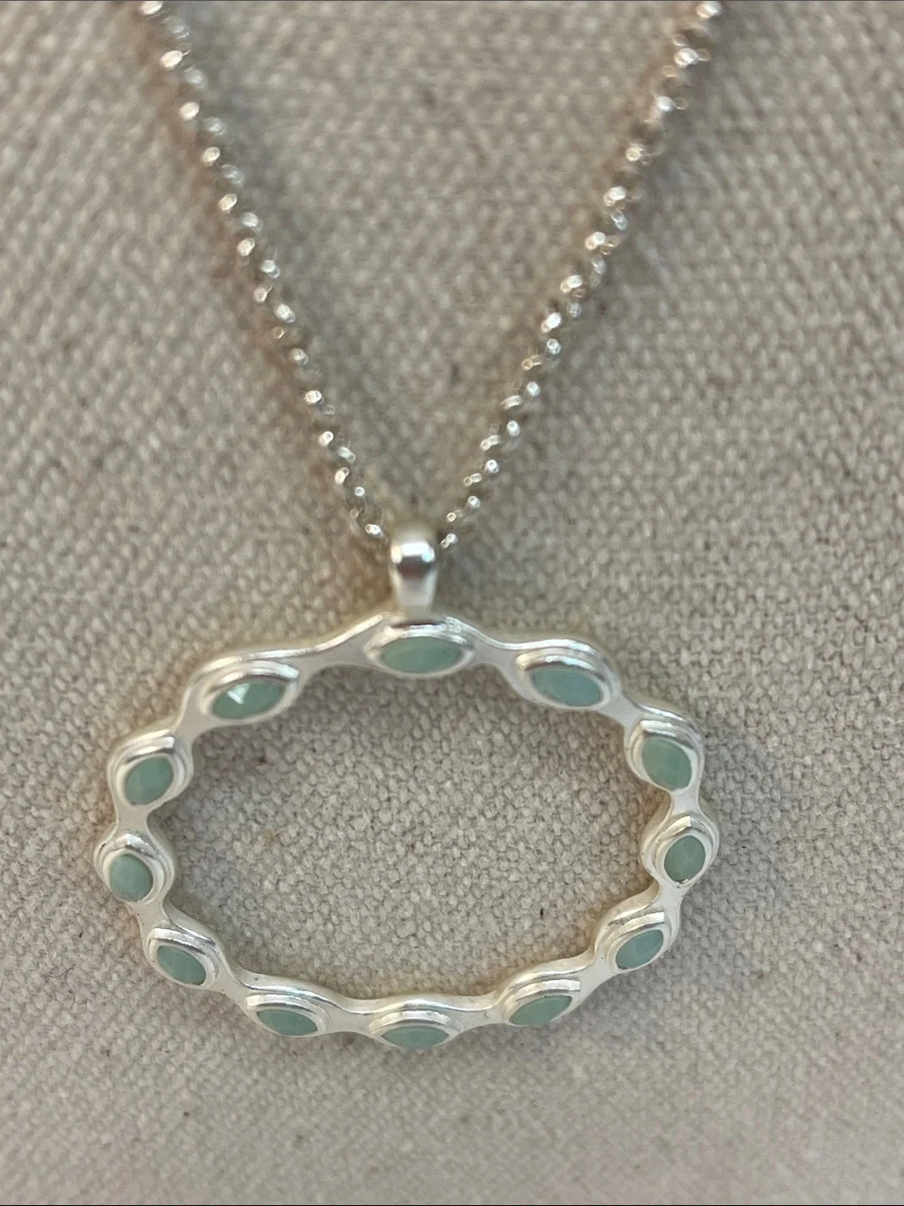 Three piece set necklace, matching earrings, light green, circular design